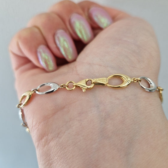 Armband två färgat guld ovala ringar