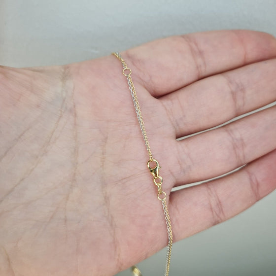 Halsband med cirklar i två-färgat guld